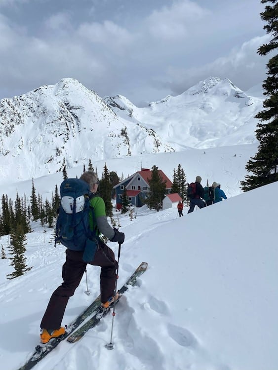 Backcountry skier approaching hut in the remote mountains