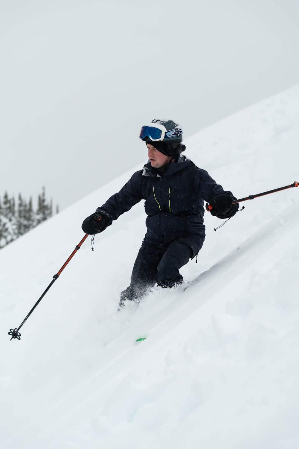 Back of backcountry skier looking over snowy mountain peak