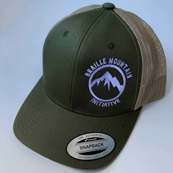 Front view of snapback trucker hat, green with beige rear color, with Braille Mountain Initiative logo stitched