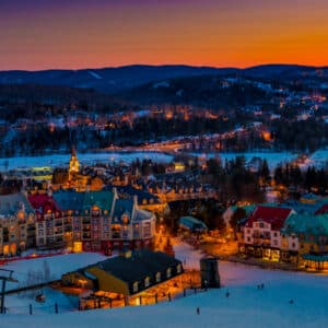 Panoramic scenery of winter night time in Mt tremblant from high altitude showing the base of the chairlift and hotel buildings