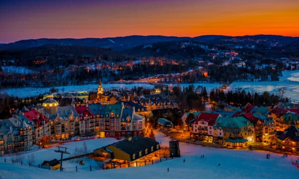 Panoramic scenery of winter night time in Mt tremblant from high altitude showing the base of the chairlift and hotel buildings