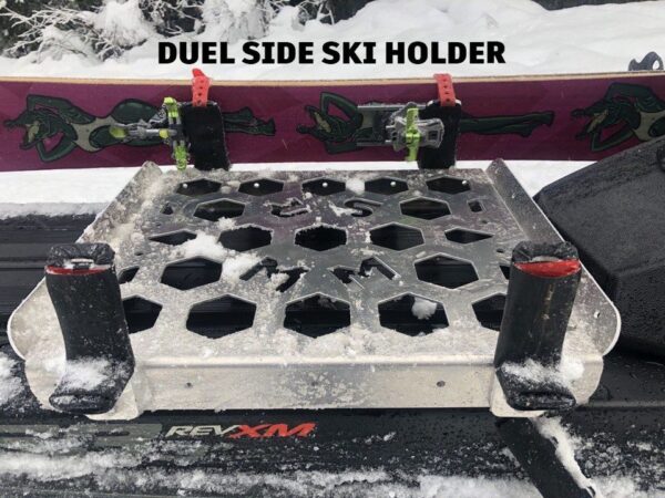 Showcasing the brackets that hold skis/disassembled splitboards onto the sled racks.