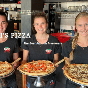 Three women dressed in black t-shirts with the Peppi's pizzeria logo on the left breast hold a large pizza in front of them.