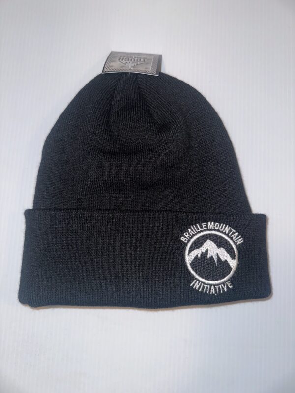 Black rib knit toque with a white Braille Mountain Initiative Logo embroidered on the cuff.