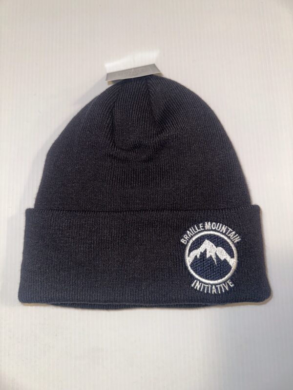 Navy blue rib knit toque with a white Braille Mountain Initiative Logo embroidered on the cuff.