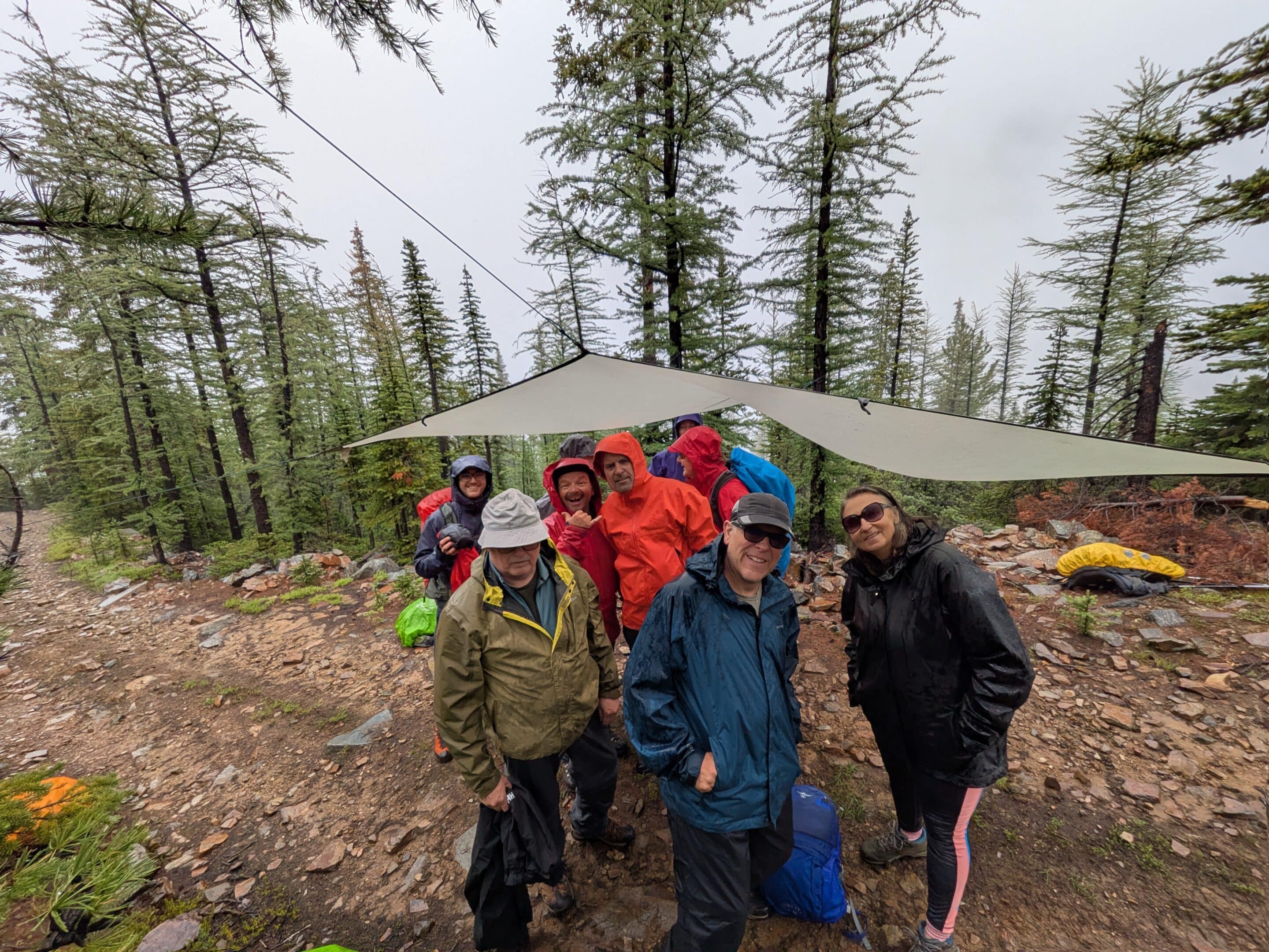 Mark Bentz, Quinn Ceplis, Lucas Desrocher, Alex Elkerton, and Tyson Rettie pose for a photo during a break while travelling up Nordic Glacier, as the sun is just peaking over the ridgeline in the background.