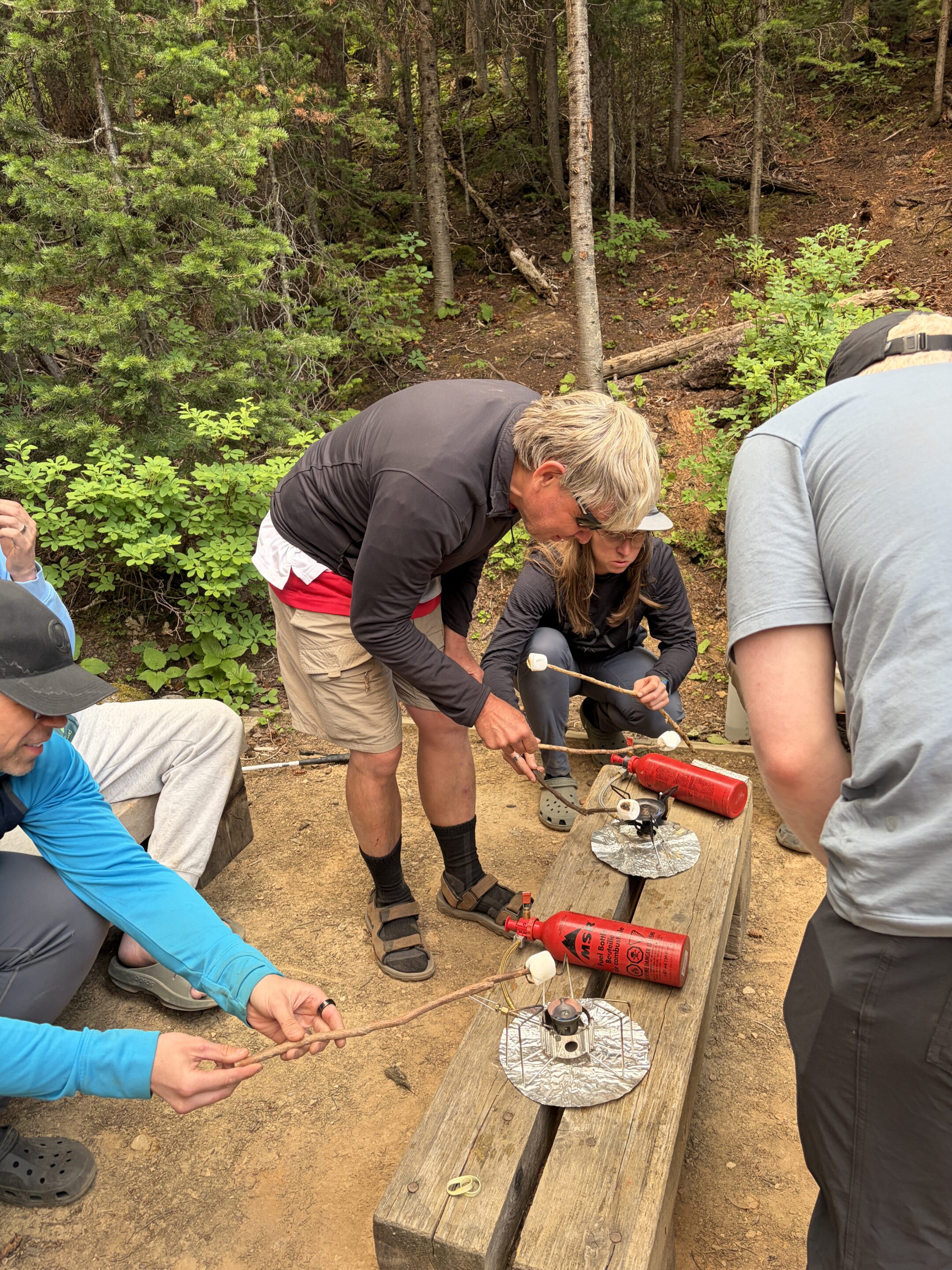 A participant cooks a marshmellow over the lightweight Whisperlite camping stove.